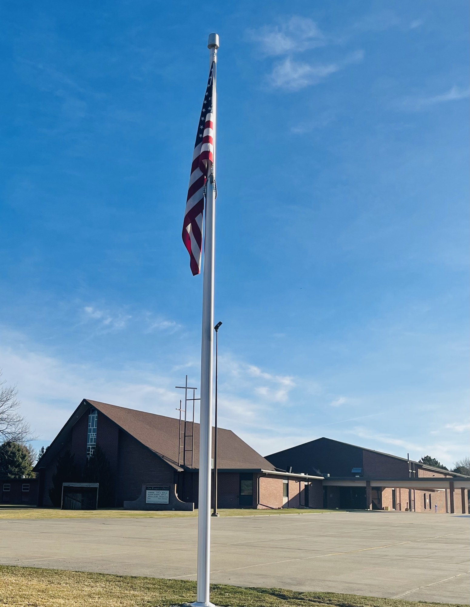 Zion Evangelical Church seen from the parking lot, flag flying